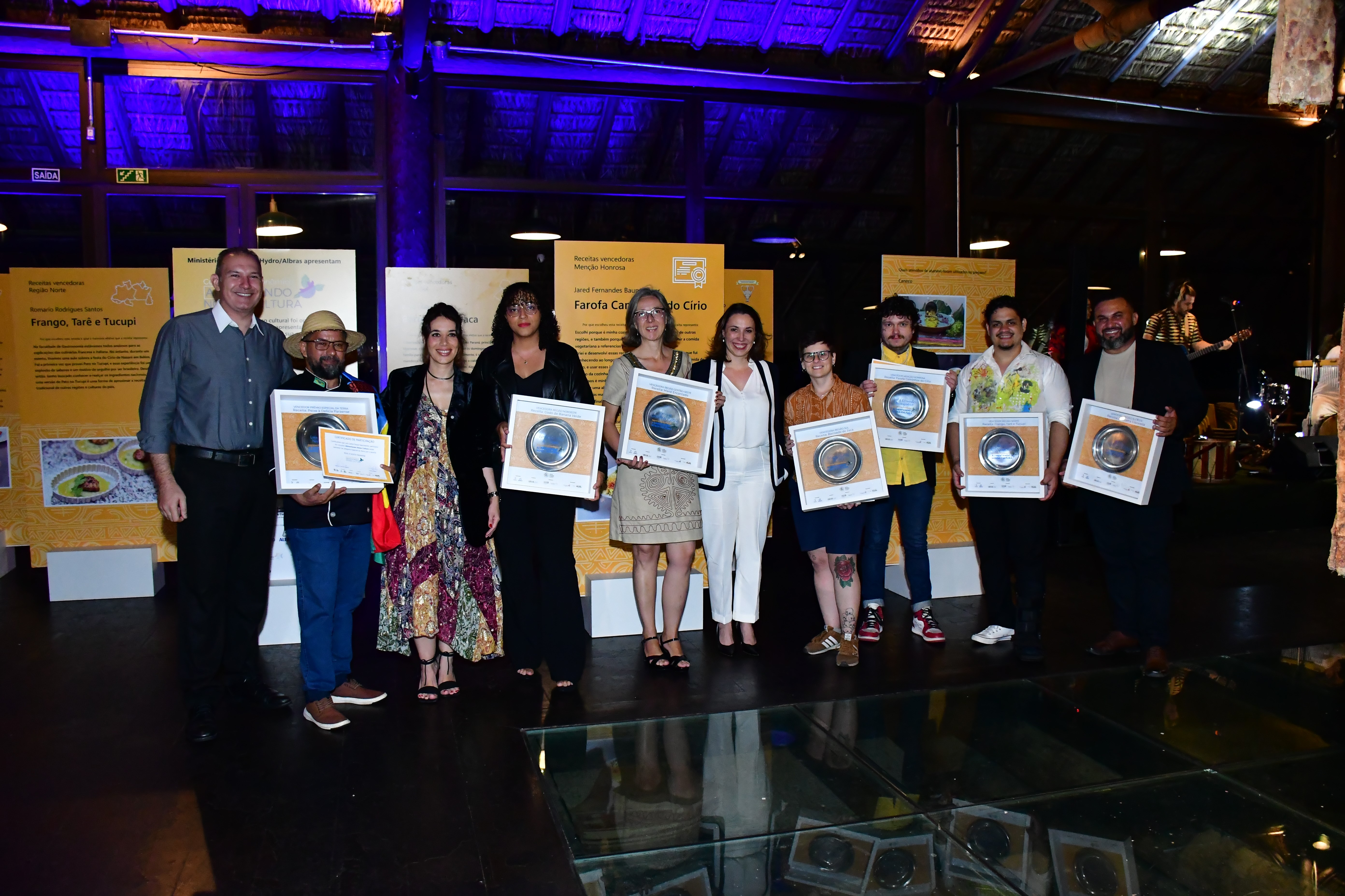 a group of people holding certificates