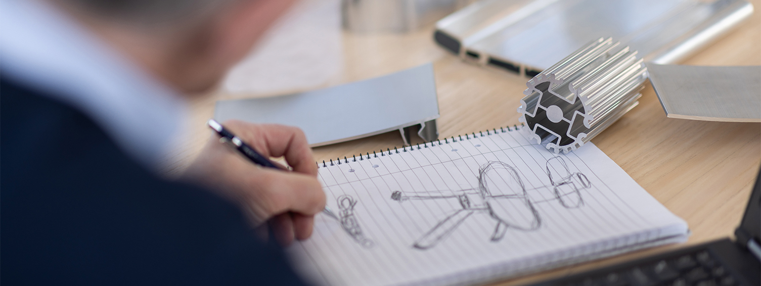 a person drawing a picture on a notebook