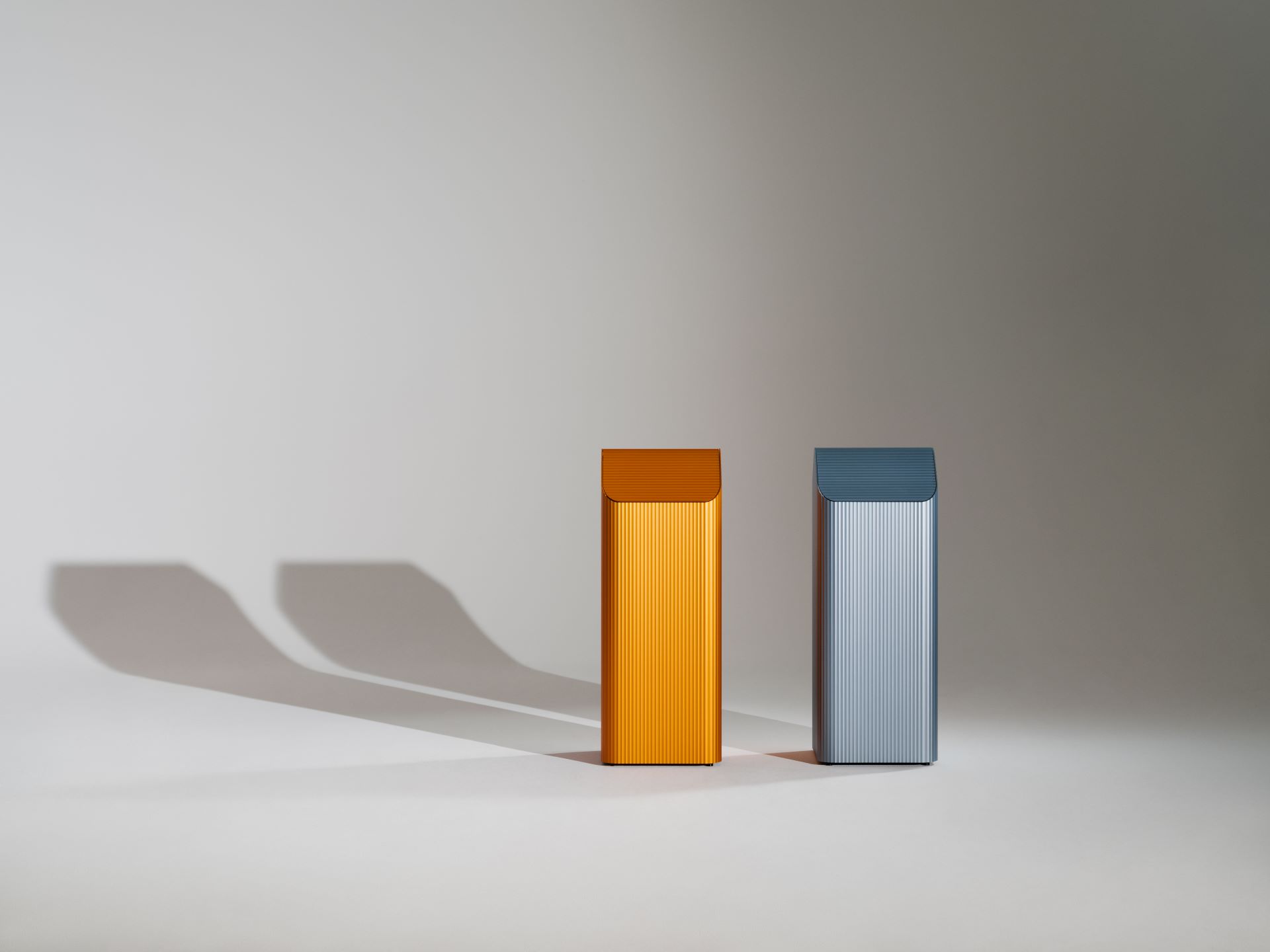 a two metal containers on a white surface