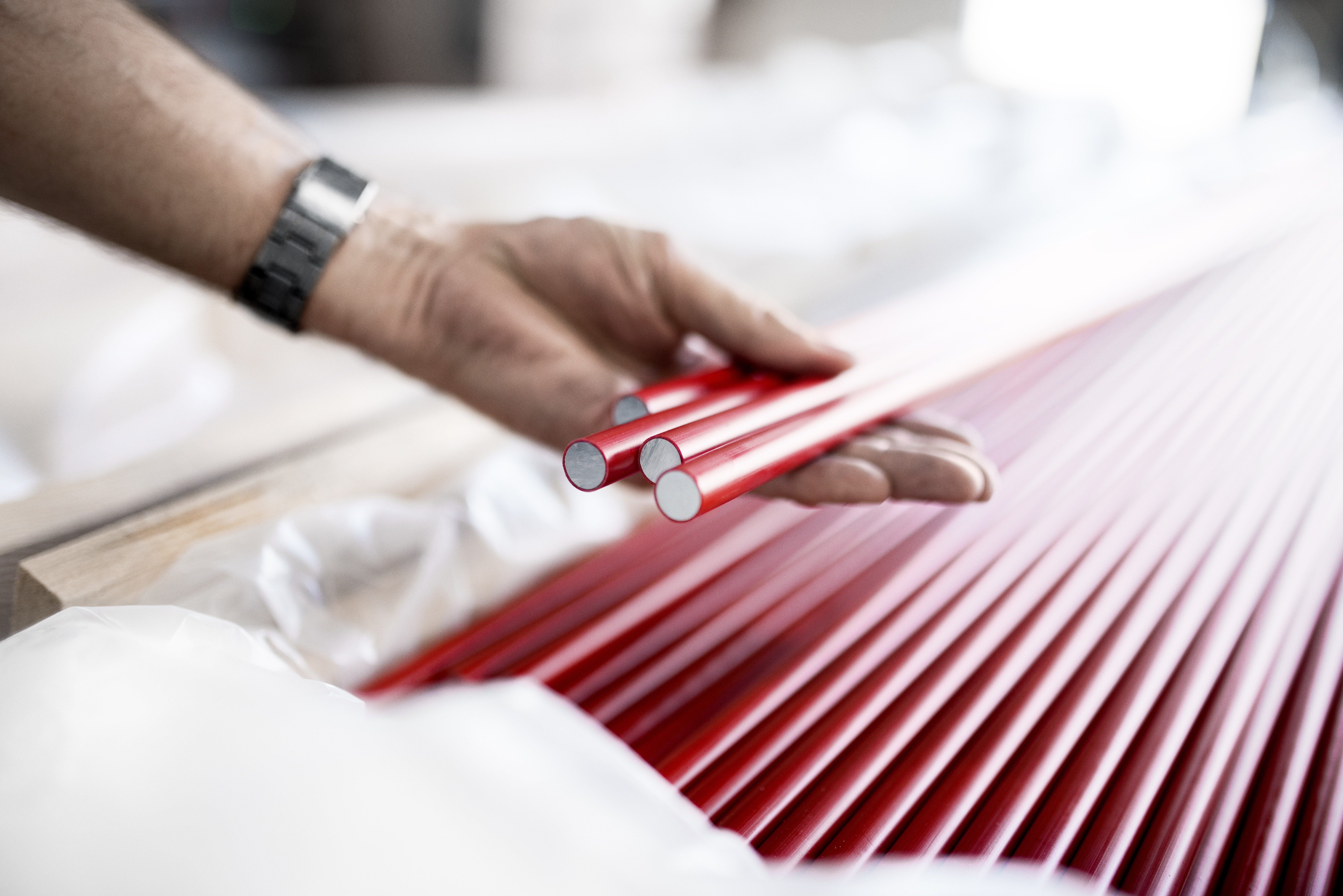 A person holding aluminium busbars