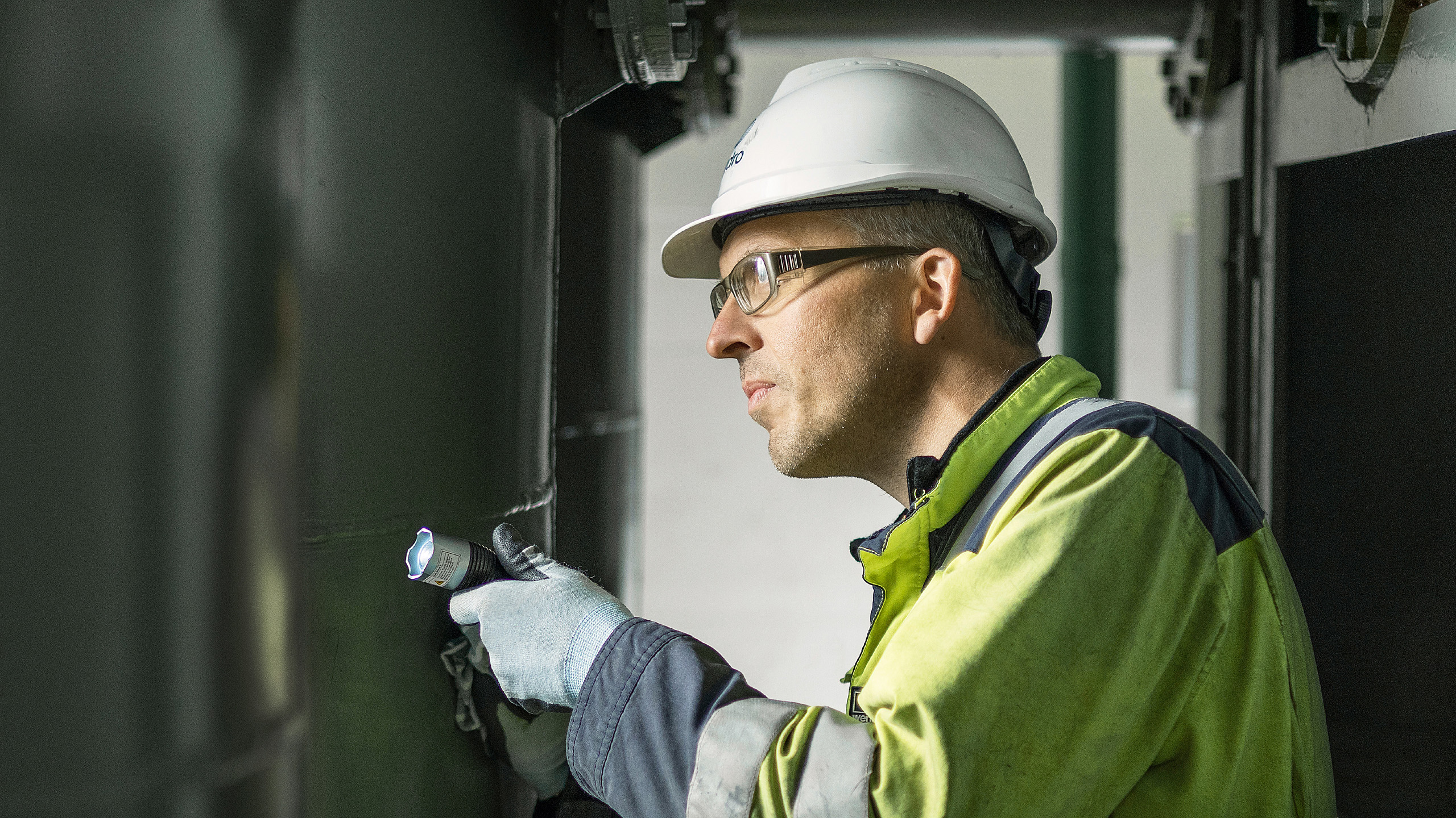 a man wearing a hard hat and safety goggles