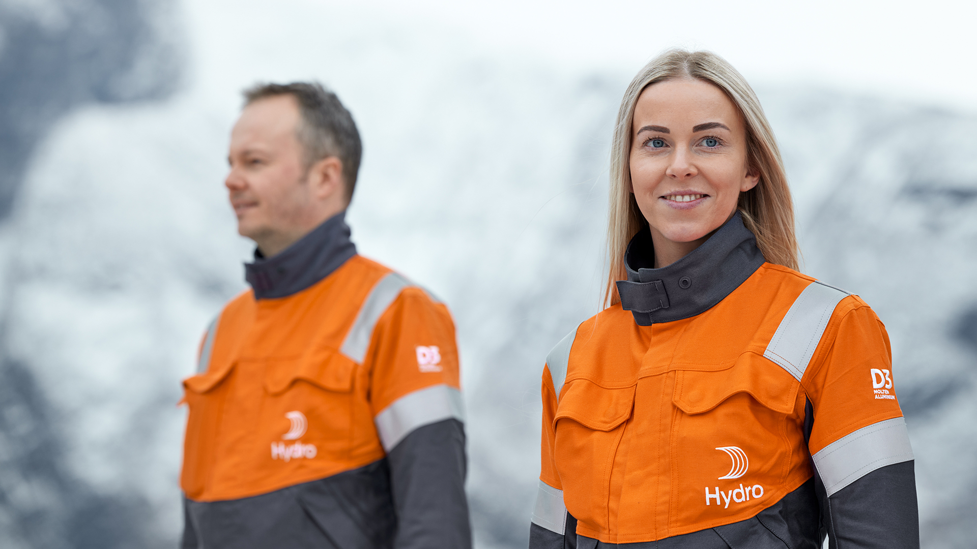 a man and a woman in orange jackets