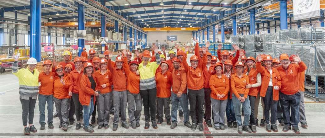 a group of people wearing orange vests