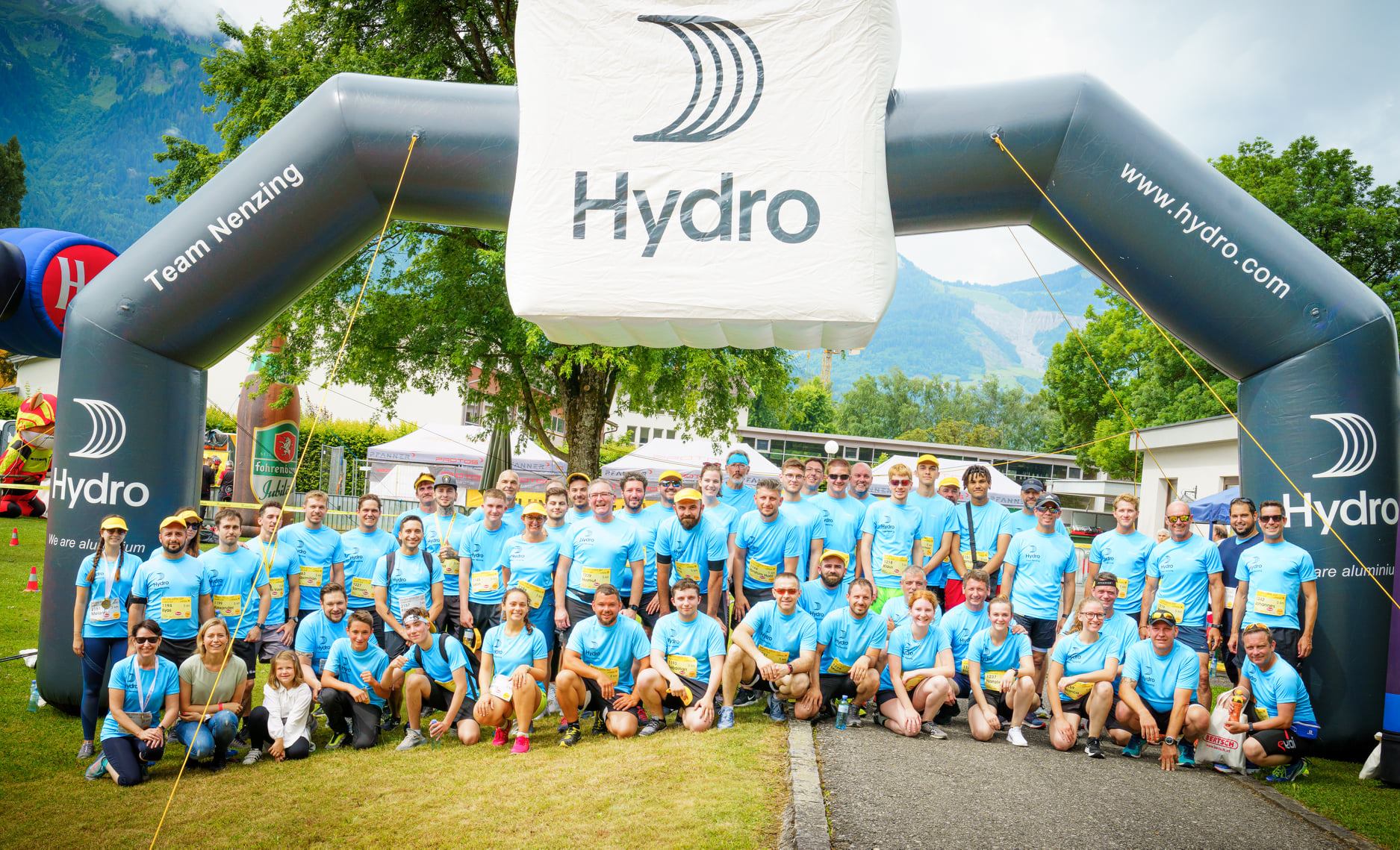 a group of people posing for a photo in front of a plane