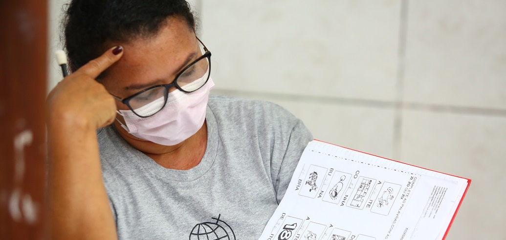 a man holding a pen to his ear