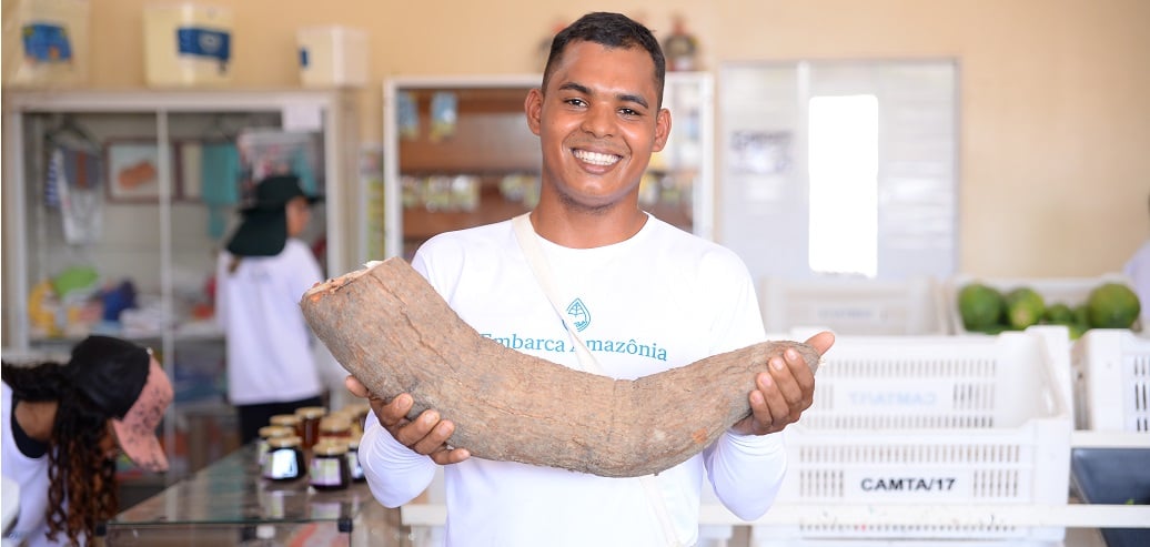 a man holding a large wooden board