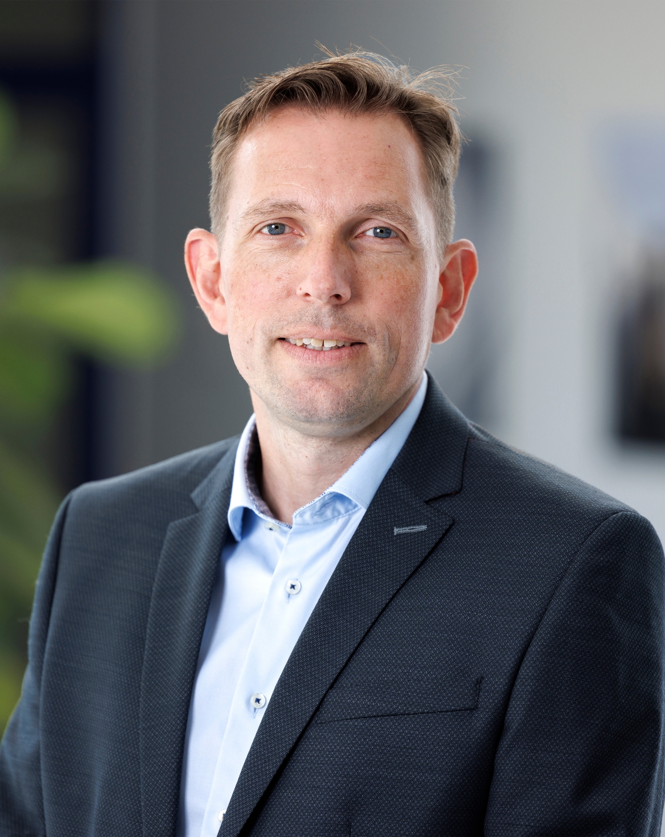 a man in a suit smiling