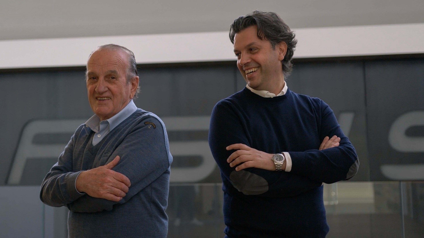 a couple of men smiling